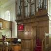 Interior. View of the sanctuary area, with the raised central pulpit set onto the organ and communion table and font to fore