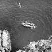 The inflatable boat moored over the site, seen from the cliff-top. (1977)