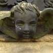 Detail of relief showing the head and wings of an angel, Rosebank Cemetery, Edinburgh.
