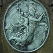 Detail of bronze relief showing an angel and cherub, Morningside Cemetery, Edinburgh.