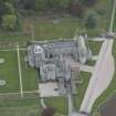 Oblique aerial view of Dunecht House adjacent chapel, looking to the W.