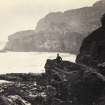 Wide view of rock formations, including figure, on the beach of Kilchattan, Colonsay.
Titled: '141. Behind Kilchattan, Colonsay.'
PHOTOGRAPH ALBUM NO 186: J B MACKENZIE ALBUMS vol.1