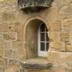 View of reused niche, now a window, on west gable of Session House, including crown canopy stone and floreate capital base.
