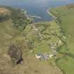 General oblique aerial view of Lochranza centred on the Isle of Arran Distillery and Golf Course, looking to the NW.