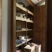 General view of cupboard on stairs showing shelves.