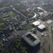 Oblique aerial view of the Glasgow Commonwealth games site including Celtic Park Stadium, looking to the S.