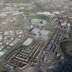 Oblique aerial view of the Glasgow Commonwealth games site including Celtic Park Stadium, looking to the N.