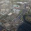 Oblique aerial view of the Glasgow Commonwealth games site including Celtic Park Stadium, looking to the NNE.