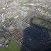 Oblique aerial view of the Glasgow Commonwealth games site including Celtic Park Stadium, looking to the NW.