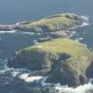 Oblique aerial view of the Flannan Isles, with the lighthouse on Eilean Mor in the foreground and Eilean Tighe beyond, looking to the S.