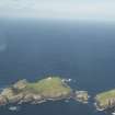 General oblique aerial view of the Flannan Isles, with the lighthouse on Eilean Mor to the left and Eilean Tighe to the right, looking to the NE.