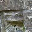 Detail of east weathered corbel to middle order of door archway.