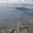 General oblique aerial view of the construction of the Queensferry, the Forth Road Bridge and Port Edgar, looking N.
