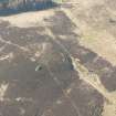 Oblique aerial view of the site of enclosure, pillboxes and trenches, looking SW.