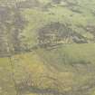 Oblique aerial view of the site of pillboxes and trenches, looking SE.