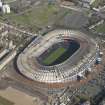 Oblique aerial view of Hampden Park being converted to a Commonwealth games venue, looking to the NE.