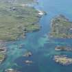 Oblique aerial view of Eilean nam Ban with Fionnphort beyond, looking SW