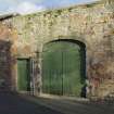 Arched entrance to coach house, view from west