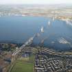 General oblique aerial view of the Forth Road Bridge and the construction of the Queensferry Crossing, looking N.