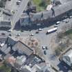 Oblique aerial view of Prestwick Market Cross, looking SE.