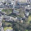 Oblique aerial view of Mauchline Old Church and Mauchline Castle, looking SE.
