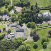 Oblique aerial view of Mortonhall House, terraced garden, stable court and granary, looking SE.