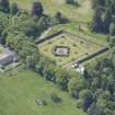 Oblique aerial view of Ballindalloch Castle walled garden and stables, looking SW.
