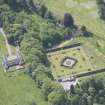 Oblique aerial view of Ballindalloch Castle walled garden and stables, looking S.