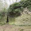 South west wall, garderobe buttress and plinth course, view from south