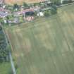Oblique aerial view of the cropmarks of the field boundary, looking SE.