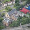 Oblique aerial view of St Mungo's Roman Catholic Church and Martyrs' Public School, looking NW.