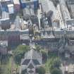 Oblique aerial view of the Canongate, Canongate Tolbooth and Huntly House, looking S.