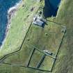 Oblique aerial view of Barra Head Lighthouse, the field boundaries and the possible dun, looking SW.