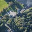 Oblique aerial view of Dunecht House Tower lodges, gates and boathouse, looking SSE.