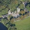 Oblique aerial view of Dunecht House Tower lodges, gates and boathouse, looking NW.