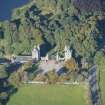 Oblique aerial view of Dunecht House Tower lodges, gates and boathouse, looking W.