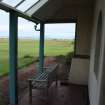 Veranda showing glazed portion of roof and battered lower wall, photograph from a historic building appraisal at Muirfield Gate, Duncur Road, Gullane