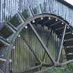View of 'start and awe' breastshot paddle type waterwheel made of wood and cast iron, from south west