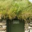 Detail of doorway showing turf growing above the roof; Dounby Click Mill, Orkney.