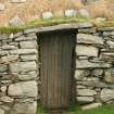 Detail of weighted thatch over doorway; 42 Arnol, Lewis.