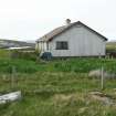 View of modern building to east of ruined 19th century cottage; Locheport, North Uist.