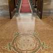 Detail of floor in entrance lobby looking down aisle to chancel.