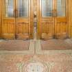 General view showing entrance hall floor and main entrance doors.