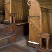 Detail of end of pews showing lino flooring.