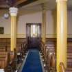 General view of aisle looking towards main entrance.