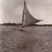 Sailing boat off the coast, titled'Messr Wilson, Farquharson on Mr Wilson's punt. Mr Jackson's house in background'. '21.7.07'. 
PHOTOGRAPH ALBUM NO.116: D M TURNBULL
