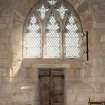 Chancel. View of East window in South wall with later door below.
