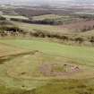 Oblique aerial view centred on the remains of Cairnpapple henge and cairn