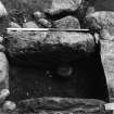 Excavation photograph showing cist with food vessel and knife.