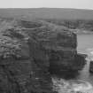 View across cliffs to the Broch of Borwick.

Glass negative.